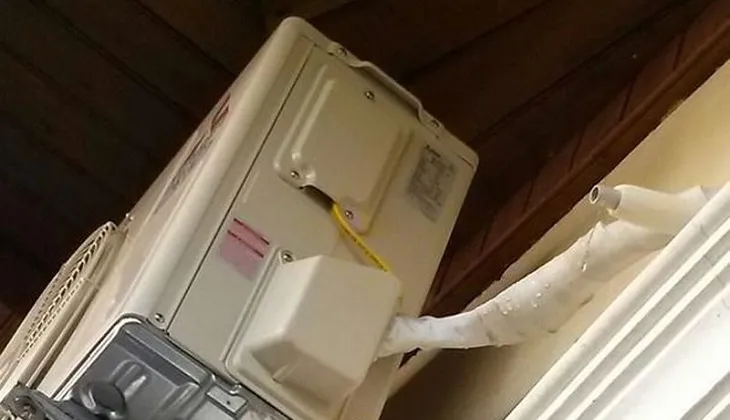 Hình ảnh cục nóng điều hòa chảy nước, có thể do lắp đặt sai kỹ thuật hoặc ống thoát bị tắc, đòi hỏi cách sửa máy lạnh bị chảy nước chuyên nghiệp.