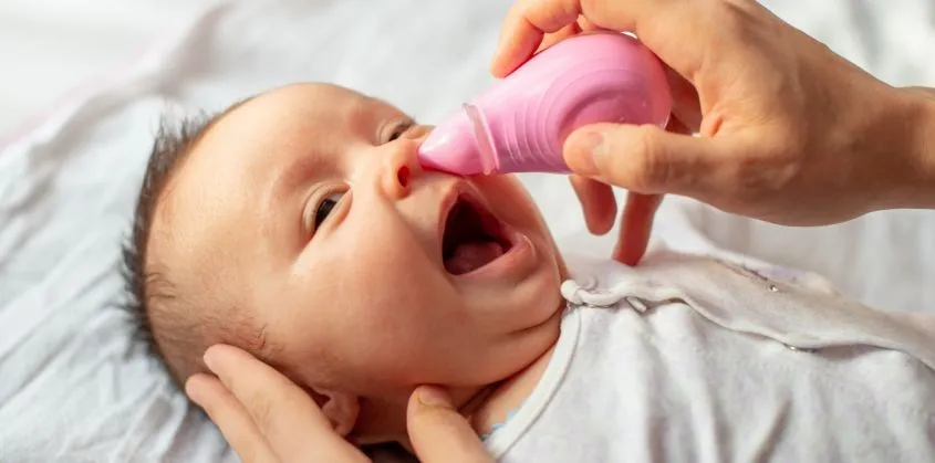 Tư thế bé nằm đúng chuẩn, đầu hơi ngửa sau giúp ba mẹ áp dụng cách sử dụng máy hút mũi cho trẻ sơ sinh an toàn.